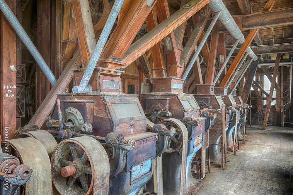 Wooden grist mill equipment in abandoned factory - obrazy, fototapety, plakaty 