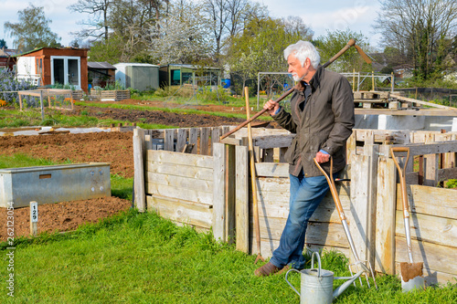 Retired mature man at allotment for outdoor hobby