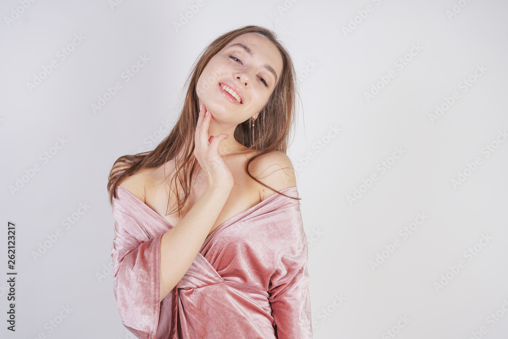cute young caucasian teenager girl in pink velvet dress stands and smiles on white background in Studio cute young caucasian teenager girl in pink velvet dress stands and smiles on white background in Studio