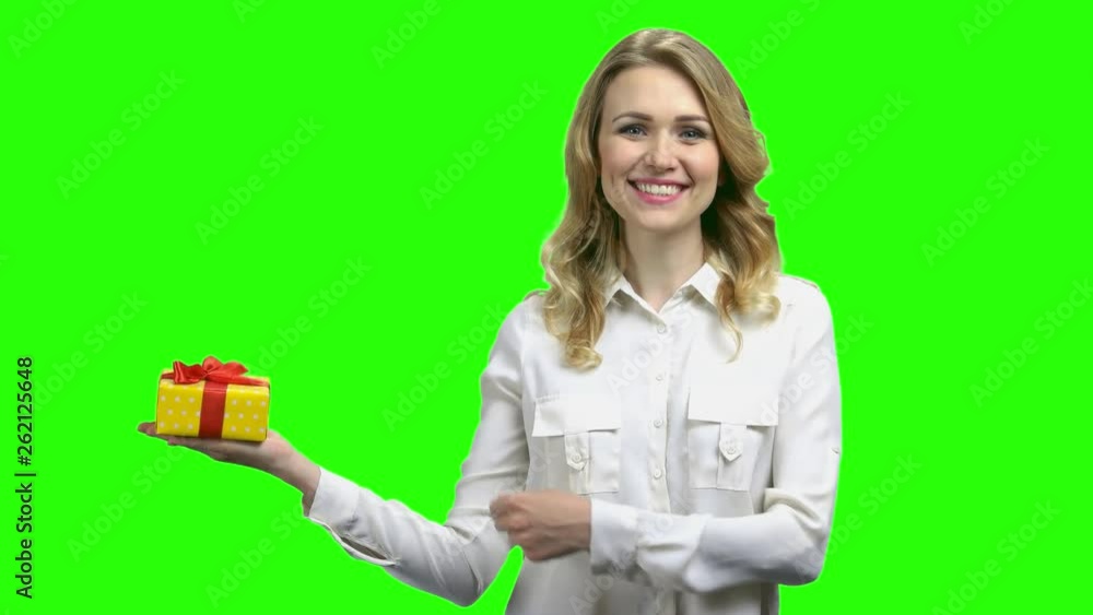 Pretty woman with gift box on palm. Portrait of young beautiful woman pointing with finger on present box standing against Alpha Channel background. Pretty woman with gift box on palm. Portrait of young beautiful woman pointing with finger on present box standing against Alpha Channel background.