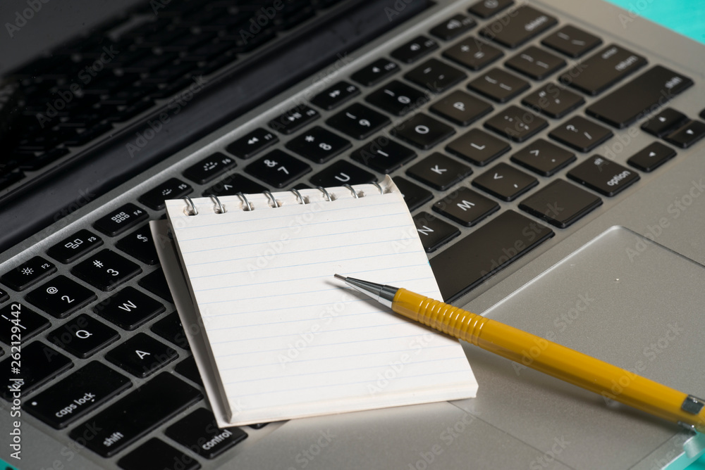 Notebook and a paper note Notebook and a paper note