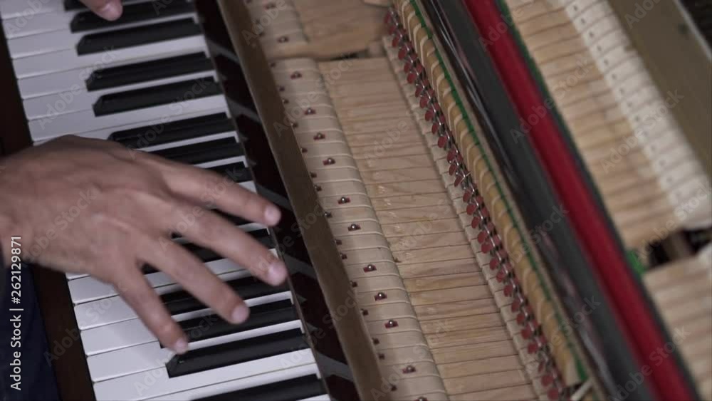 Musician plays open piano, Slow Motion Top View Medium shot with shallow depth of field Musician plays open piano, Slow Motion Top View Medium shot with shallow depth of field