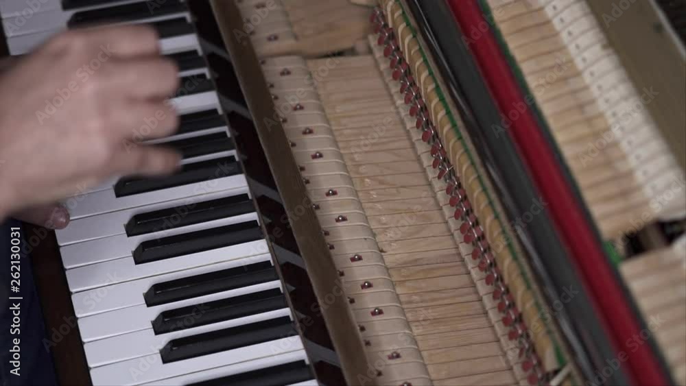 Musician plays open piano, Slow Motion Top View Medium shot with shallow depth of field Musician plays open piano, Slow Motion Top View Medium shot with shallow depth of field