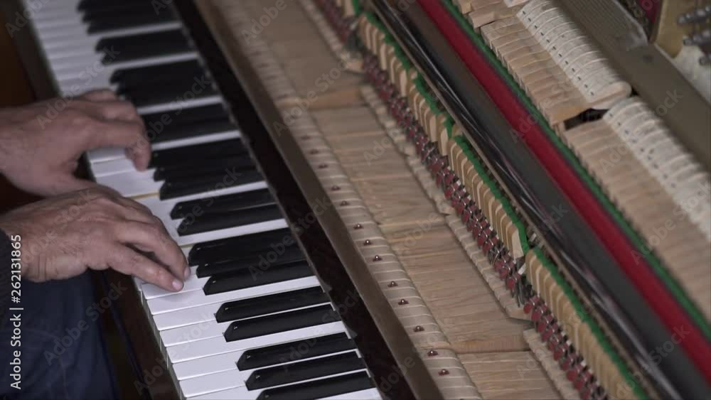 Musician plays open piano, Slow Motion Top View Medium shot with shallow depth of field Musician plays open piano, Slow Motion Top View Medium shot with shallow depth of field