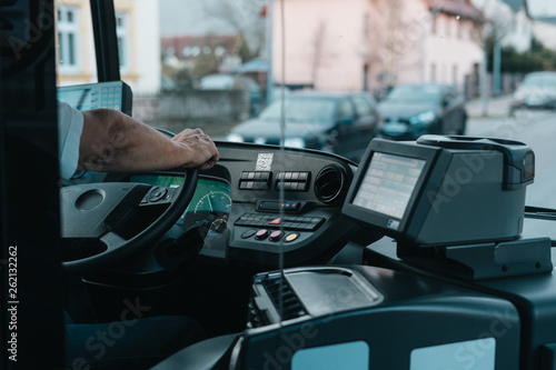 Modern bus interior with drivers hand