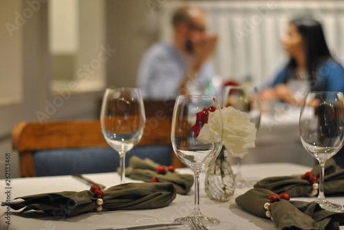 Glasses in romantic dinner with couple