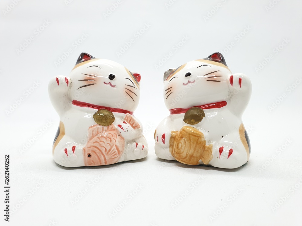 Porcelain Cat Statue representing luck symbol and sign for traditional chinese culture presented in white isolated background Porcelain Cat Statue representing luck symbol and sign for traditional chinese culture presented in white isolated background
