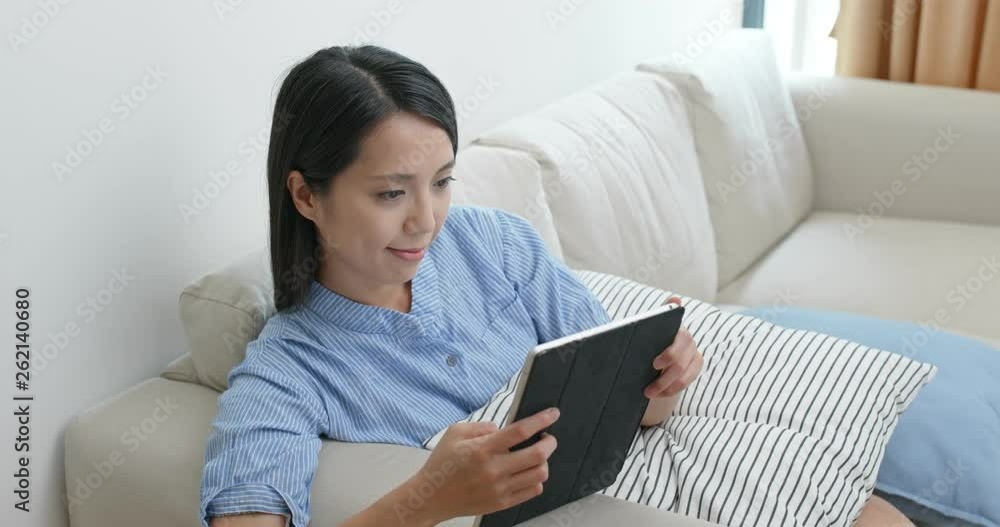Woman look at tablet computer at home Woman look at tablet computer at home