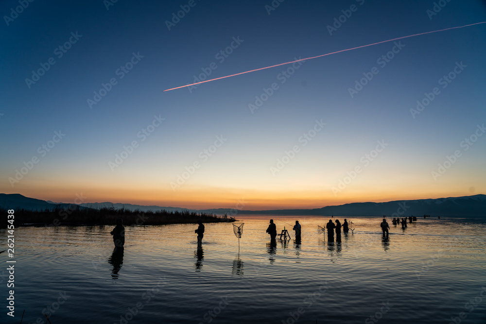 sunset on the lake with jet trail