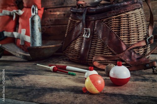 Foto Fishing bobbers with vintage Creel basket