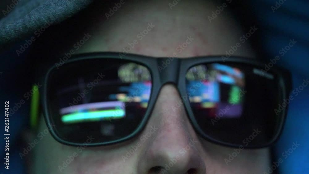 Anonymous Hacker in Dark Glasses Looking at Computer Screen Code Reflections Anonymous Hacker in Dark Glasses Looking at Computer Screen Code Reflections