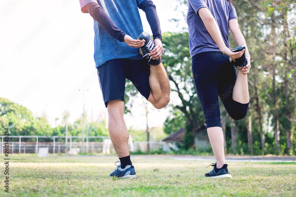 Early morning workout, Fitness couple stretching outdoors in park. Young man and woman exercising together in morning, Living healthy lifestyle fitness, sport concept.
