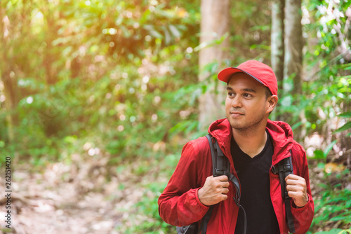 Asian travel handsome man hiking in forest and mountain enjoy walking in nature outdoors.