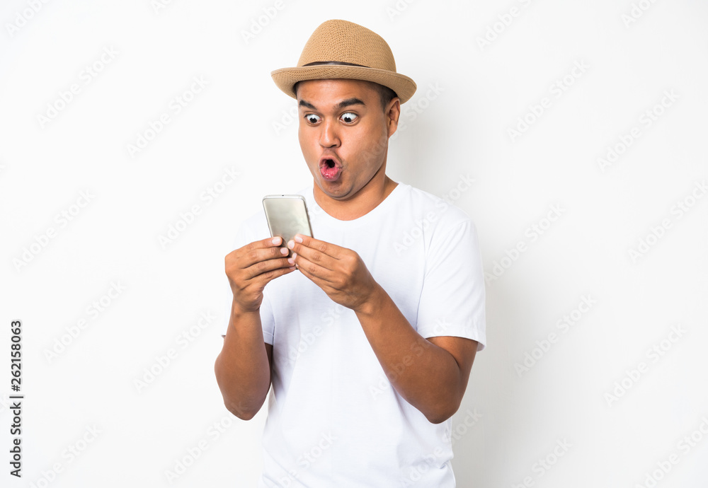 Surprised and shocked asian man looking smartphone Surprised and shocked asian man looking smartphone