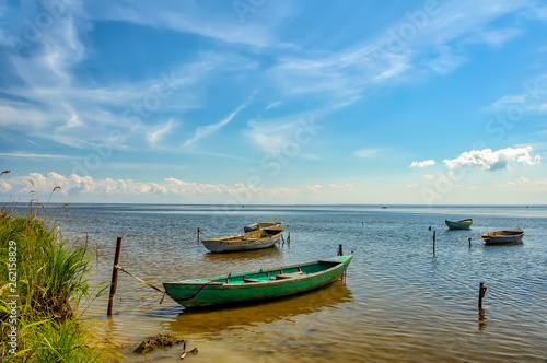 Fishing boats, standing on the pier in lake Ladoga. Sunny summer day. © zoya54