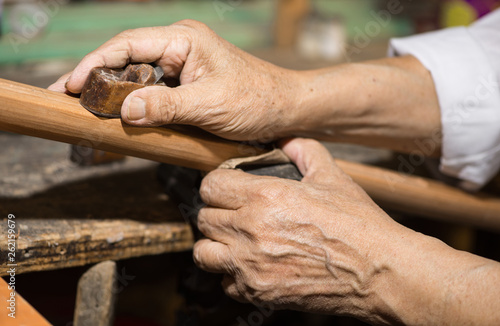 adult master restores old musical instruments. wood carving © warloka79