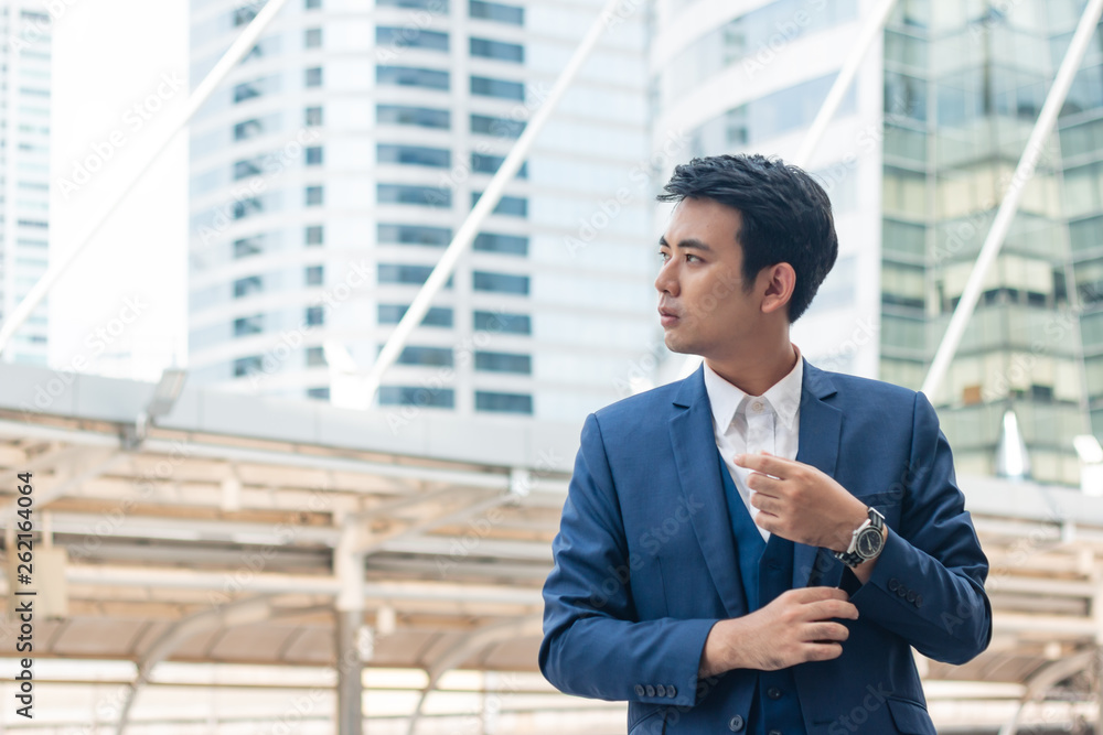 Young businessman adjusting cufflink his blue suit. Young businessman adjusting cufflink his blue suit.