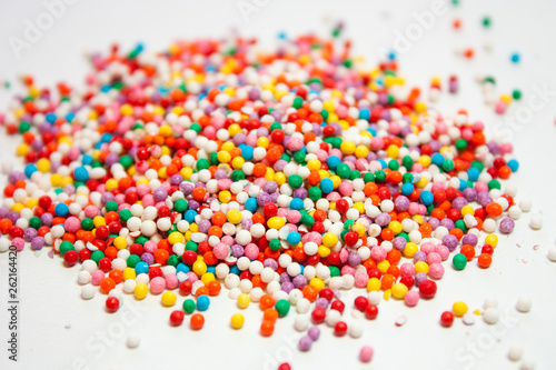 A pile of candy topping close up on a white background