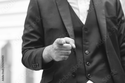 Close up businessman pointing finger on city background. black and white