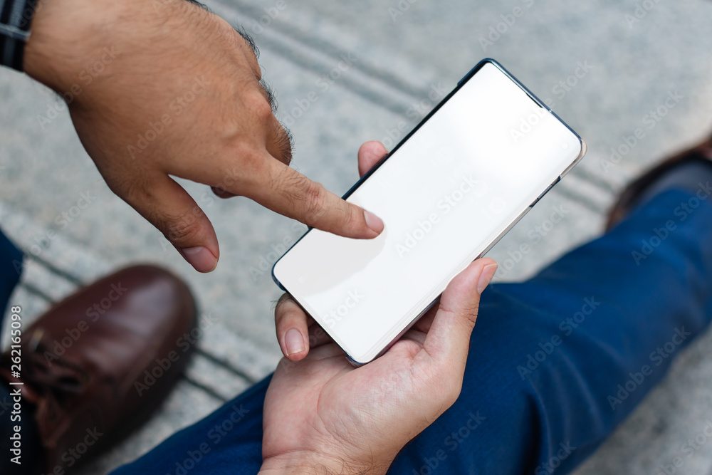 Finger pointing on the smart phone with white desktop. business and technology concept Finger pointing on the smart phone with white desktop. business and technology concept