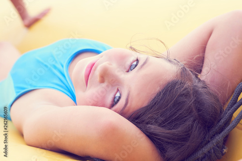 Cute little girl relaxing lying on inflatable mattress close-up portrait.