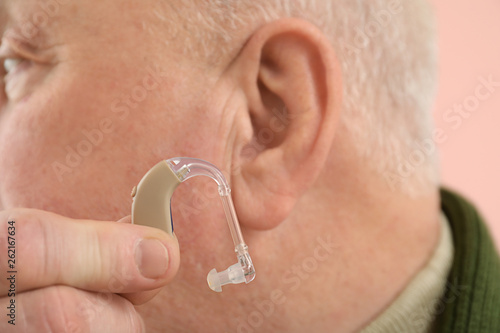 Senior man with hearing aid...