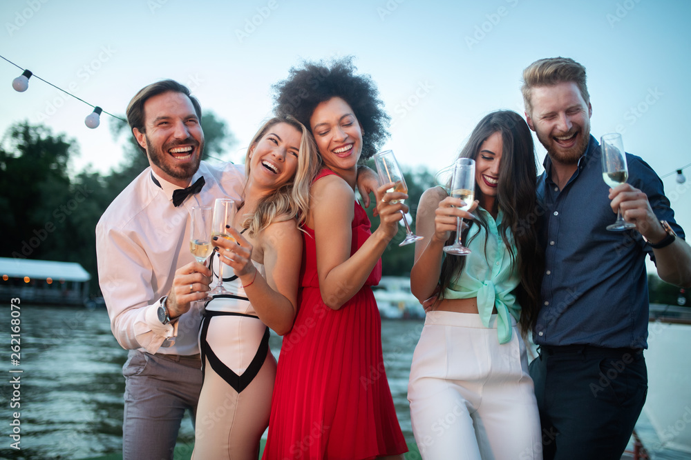 Group of happy friends drinking champagne and celebrating New Year Group of happy friends drinking champagne and celebrating New Year