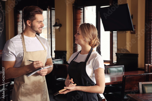 Naklejka Young waiters in restaurant