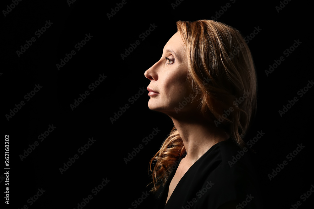 Mature woman on dark background Mature woman on dark background