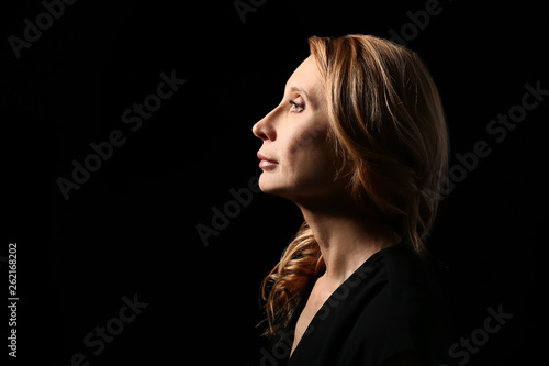 Mature woman on dark background