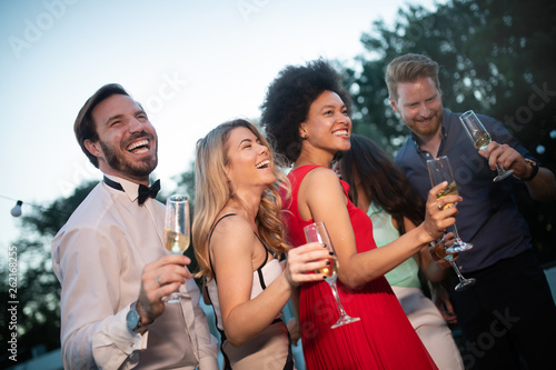 Group of happy people or friends having fun at party