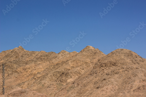 sand stone bare mountain background horizon board with blue sky, wilderness desert natural wallpaper environment 