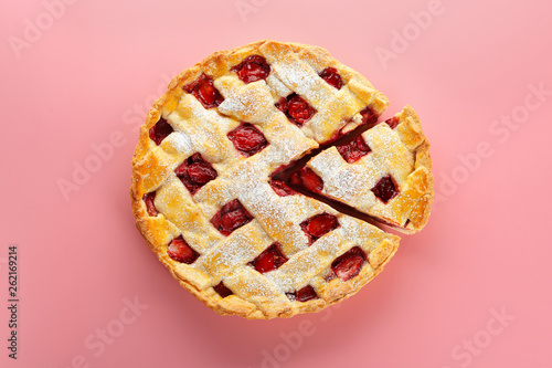 Tasty strawberry pie on color background