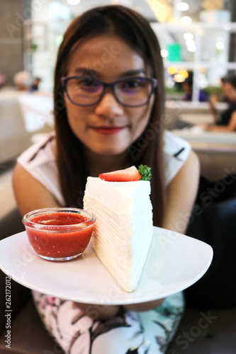 young woman eating ice cream in cafe
