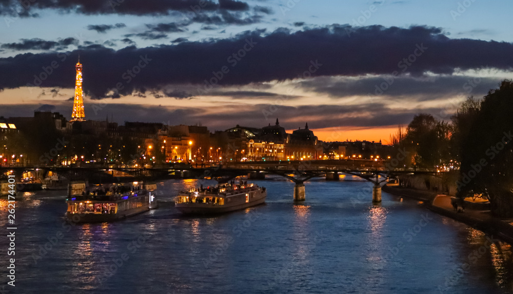 Beautiful night Paris, sparkling tower, bridge over the River Seine and touristic boats. France