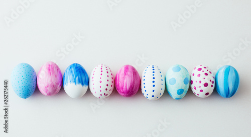 Painted easter eggs in a row, side by side. Isolated on white background