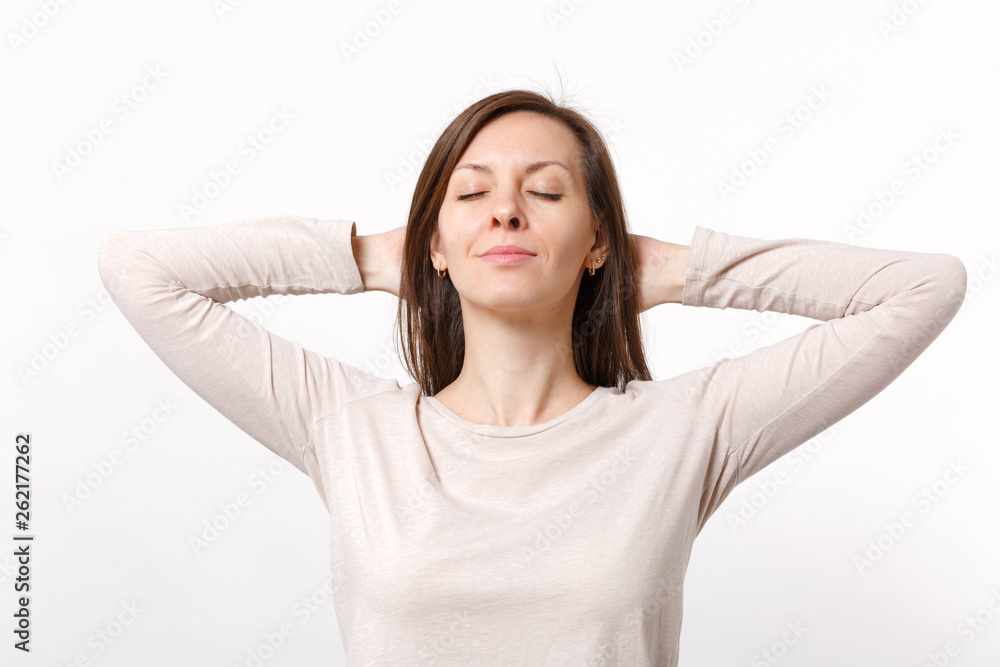 Portrait of relaxed young woman in light clothes keeping eyes closed, holding hands behind head isolated on white background in studio. People sincere emotions, lifestyle concept. Mock up copy space. Portrait of relaxed young woman in light clothes keeping eyes closed, holding hands behind head isolated on white background in studio. People sincere emotions, lifestyle concept. Mock up copy space.