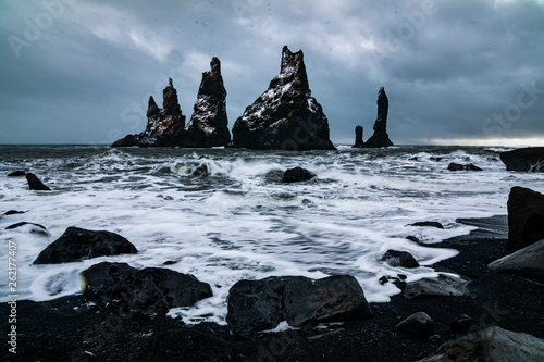 Basalt rocks Troll toes on black beach. at storm Reynisdrangar, Vik, Iceland.