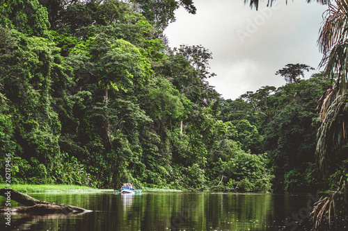 Jungle expedition with small boat photo