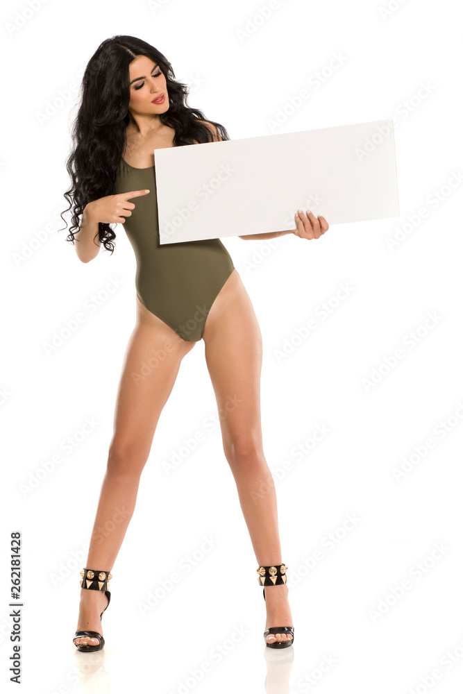 Attractive brunette with blank board in one piece swimsuit on white background Attractive brunette with blank board in one piece swimsuit on white background