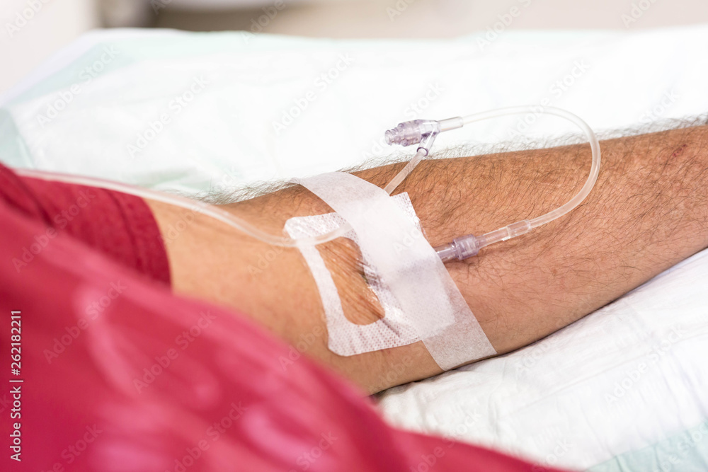 Fototapeta premium man in hospital having an intravenous drip immunoglobulin infusion