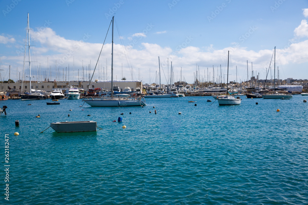 Panoramic view in Sliema, sailing boat and beautiful green waters of Mediterranean sea. Malta country. 