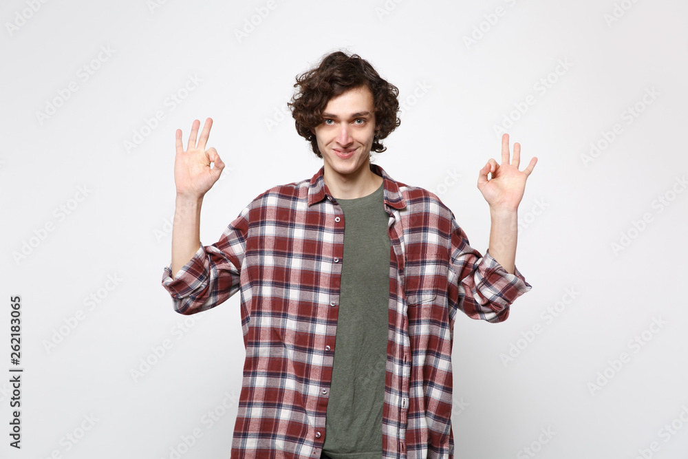 Portrait of smiling young man in casual clothes hold hands in yoga gesture, relaxing meditating isolated on white background in studio. People sincere emotions, lifestyle concept. Mock up copy space. Portrait of smiling young man in casual clothes hold hands in yoga gesture, relaxing meditating isolated on white background in studio. People sincere emotions, lifestyle concept. Mock up copy space.