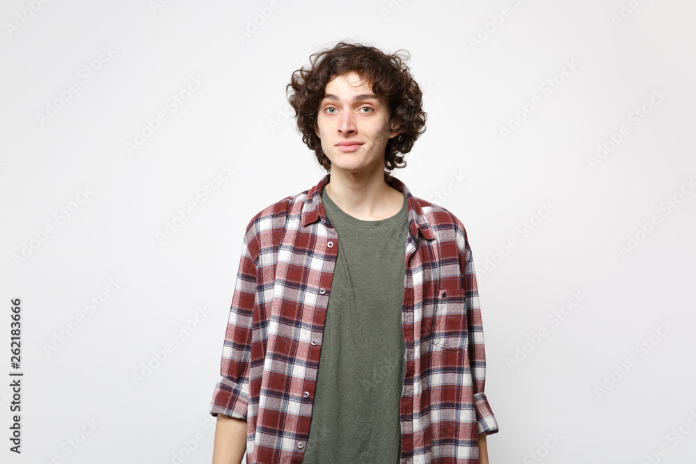 Portrait of smiling attractive young man in casual clothes standing and looking camera isolated on white wall background in studio. People sincere emotions, lifestyle concept. Mock up copy space. Portrait of smiling attractive young man in casual clothes standing and looking camera isolated on white wall background in studio. People sincere emotions, lifestyle concept. Mock up copy space.