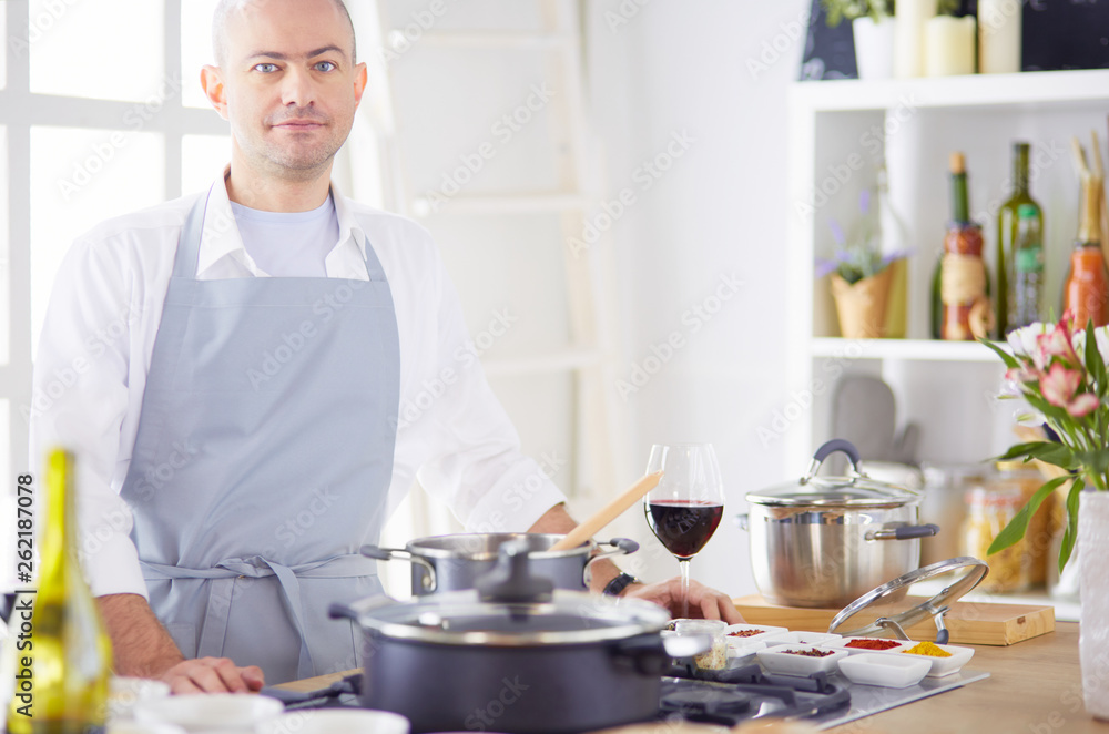 Couple cooking together in the kitchen at home Couple cooking together in the kitchen at home