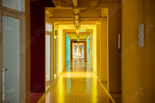 The colorful hallway interior empty with glass door.