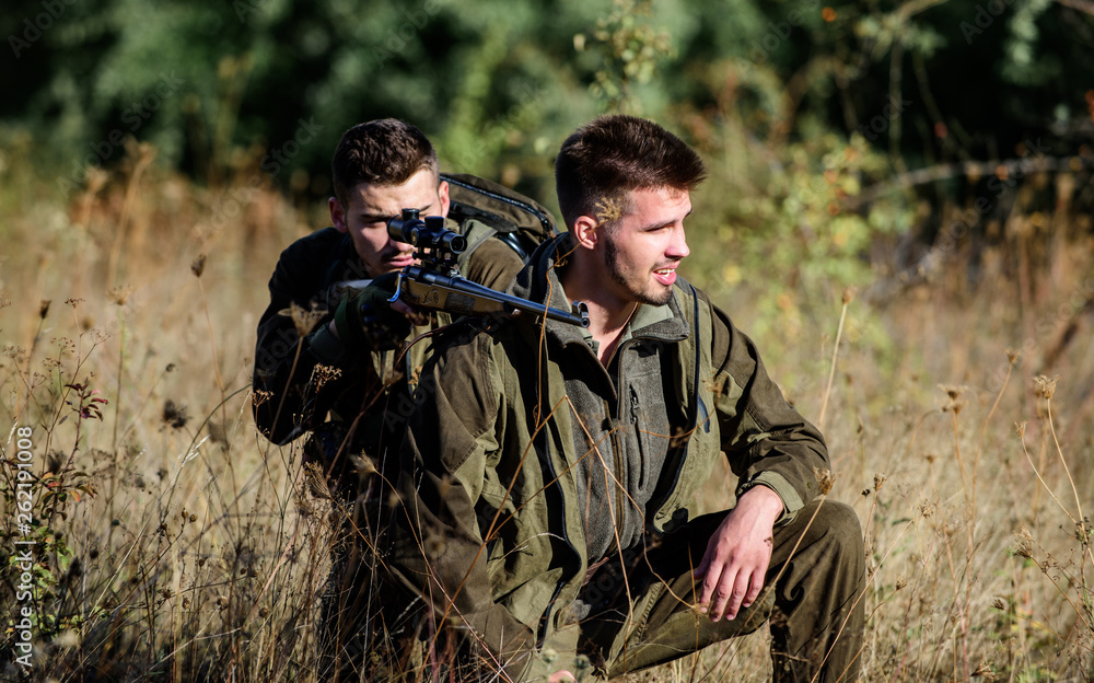 Teamwork and support. Activity for real men concept. Hunters with rifles in nature environment. Hunters gamekeepers looking for animal or bird. Hunting with friends. Hunters friends enjoy leisure Teamwork and support. Activity for real men concept. Hunters with rifles in nature environment. Hunters gamekeepers looking for animal or bird. Hunting with friends. Hunters friends enjoy leisure