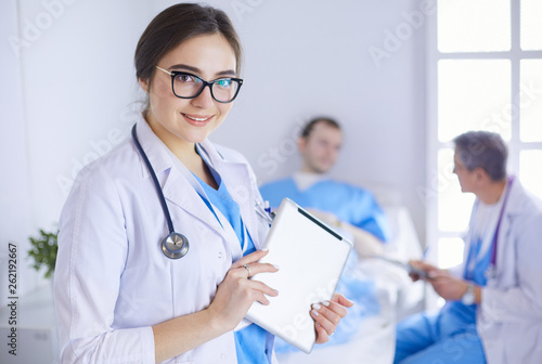 Female doctor using tablet computer in hospital lobby