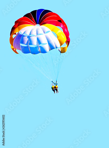 together to descend from a paraglider to the earth in a clear sky