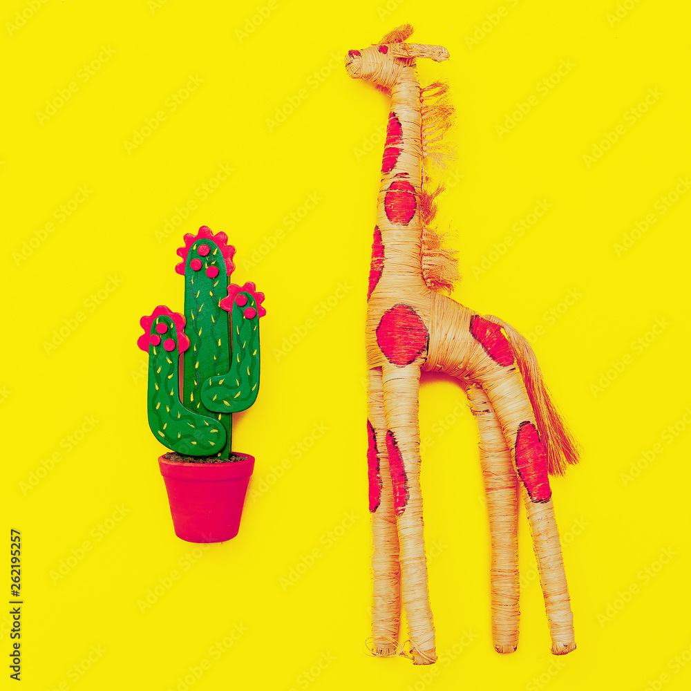 Wooden cactus and giraffe on a yellow background. Souvenir. Minimal. Flat lay art